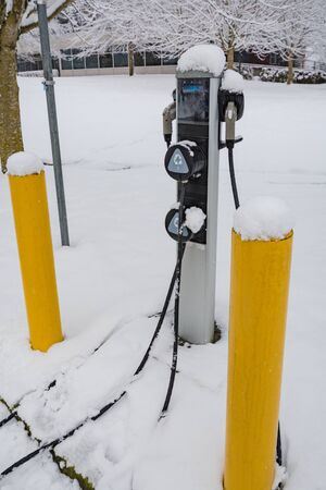 EV charging station for zero emission cars on white snow backgroundの写真素材