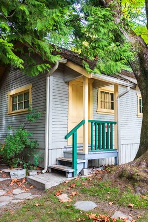 Doorsteps and porch of small residential house under the tree
