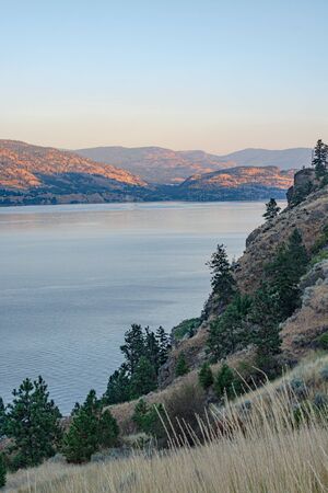 Scenery overview of Okanagan lake on summer sunsetの写真素材