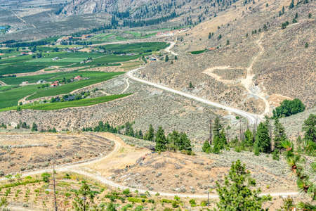 Landscape with orchard farms at Okanagan lake on hot summer dayの写真素材