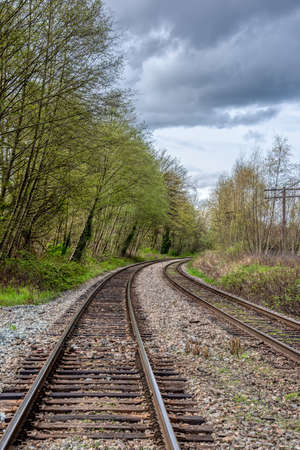Curve of rail road pathways leading to a cityの写真素材