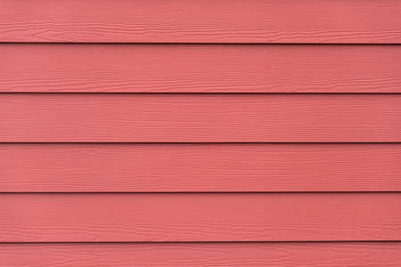 Red colored siding backdrop with wooden plank texture