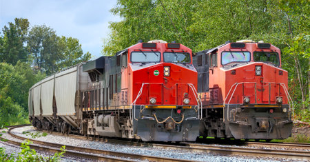 Two red locomotives are waiting for the semaphore signalの写真素材