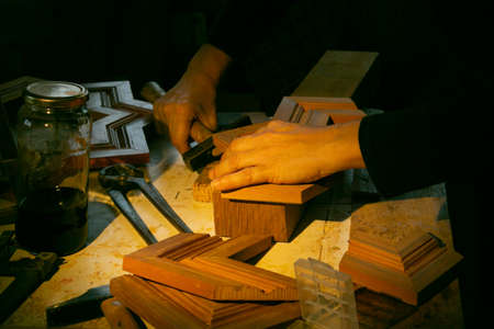 woman carpenter working with wood by hand