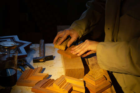 woman carpenter working with wood by hand