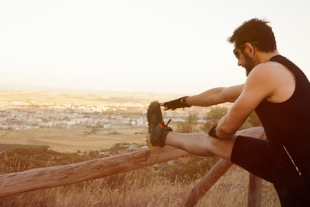 man running through the countryside with rock formationsの写真素材