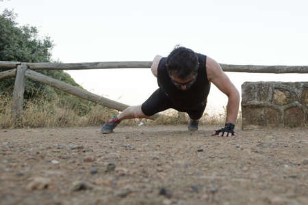 man running through the countryside with rock formations