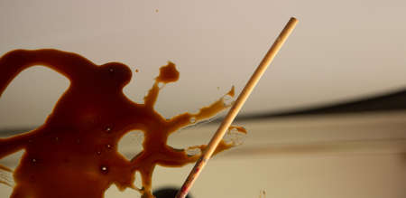 Stain of balsamic vinegar with a brush and written letters, abstractの写真素材