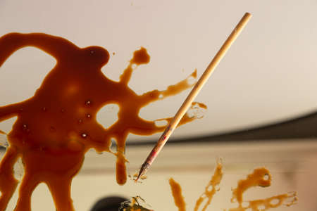 Stain of balsamic vinegar with a brush and written letters, abstractの写真素材