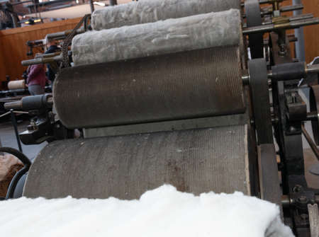 Old loom, spinning machine, rows of white and colored cotton threads