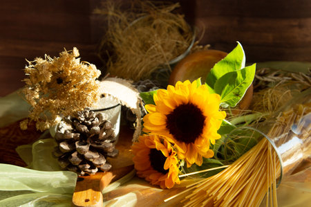 Three beautiful yellow sunflowers in a glass vase are standing on the windowsill of a modern window close-upの写真素材
