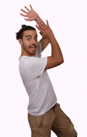 young man in white T-shirt with white background making funny gesturesの写真素材