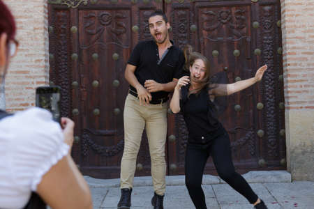 Young Caucasian couple on holiday, making funny and funny gestures, in Cordobaの写真素材