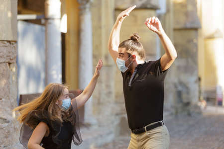 Young couple dancing and having fun on the street while travelling in the old part of Cordoba, Spain.の写真素材