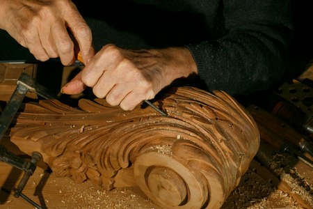 Craftsmans hands working on wood carving, with gouge and chisel Cabinetmaker, carpentry
