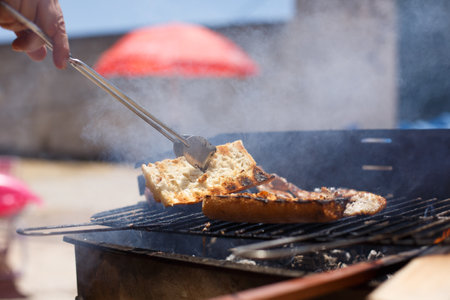Toasted bread on homemade barbecue, outside on a sunny day.の写真素材