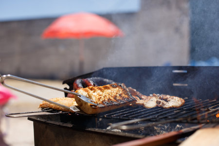 Toasted bread on homemade barbecue, outside on a sunny day.の写真素材