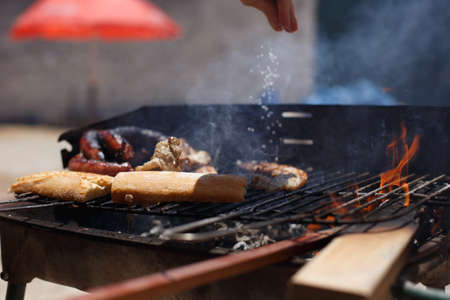 Toasted bread on homemade barbecue, outside on a sunny day.の写真素材
