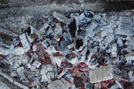 charcoal burning under a grill at a barbequeの写真素材