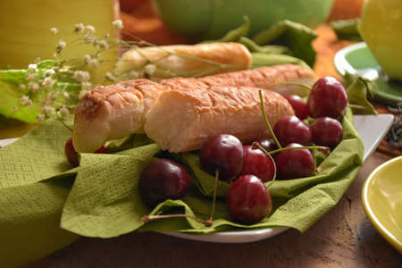 cherries and pastas with tea set in green and yellow colourの写真素材