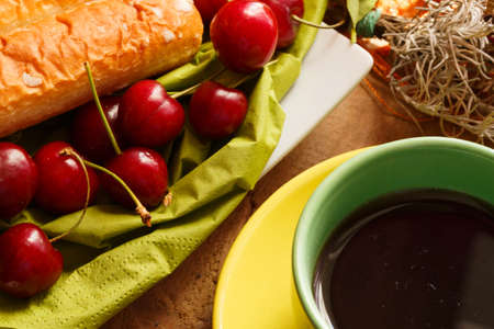 cherries and pastas with tea set in green and yellow colourの写真素材