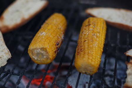 Cooking corn on the cob on the grill, outside the houseの写真素材