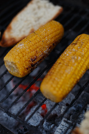 Cooking corn on the cob on the grill, outside the houseの写真素材