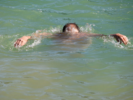 obese man bathing in lake water, mountain nativeの写真素材