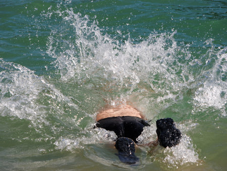 obese man bathing in lake water, mountain nativeの写真素材