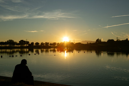 A Serene Sunset Reflection Over a Tranquil Lake, peacefully capturing beauty and calmness in natureの写真素材