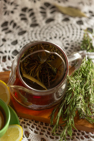 A calming herbal tea infusion beautifully presented with fresh herbs, fragrant aromas, and zesty lemonsの写真素材