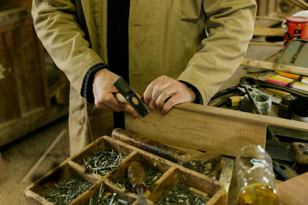 An Individual Carefully Assesses Timber Materials Amidst Chaotic Workshop Filled With Antique Tools
