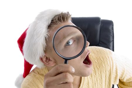 man wearing santa hat and looking through lens on an isolated backgroundの写真素材