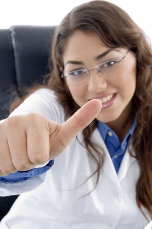 smiling doctor with thumbs up against white backgroundの写真素材
