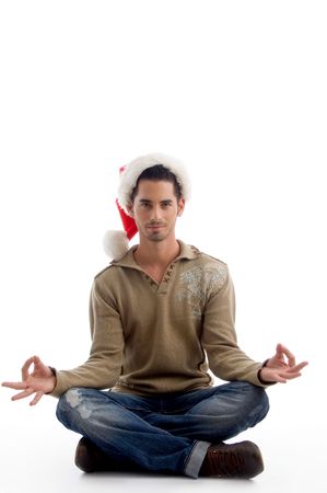 handsome man wearing christmas hat and doing meditation on an isolated white backgroundの写真素材
