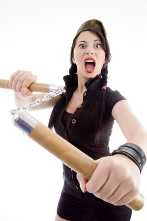 attractive young female holding nunchaku with white backgroundの写真素材