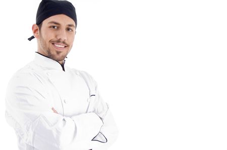 male chef posing with crossed arms and looking at camera on an isolated backgroundの写真素材