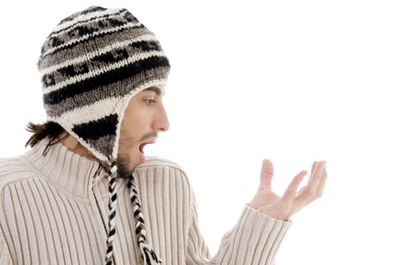 handsome man surprised and holding something with hand gesture against white background