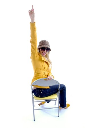 side view of sitting model pointing on an isolated white backgroundの写真素材