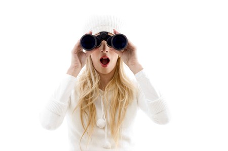 front view of amazed woman looking through binoculars against white backgroundの写真素材