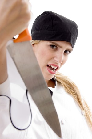 front view of aggressive female cook on an isolated backgroundの写真素材