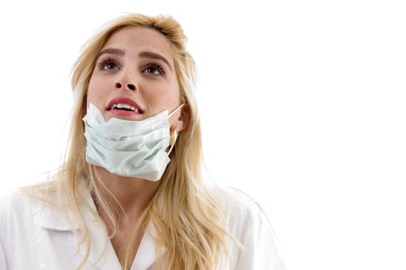 front view of doctor with facemask on an isolated backgroundの写真素材