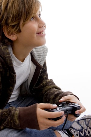 side view of glad young kid enjoying videogame against white background