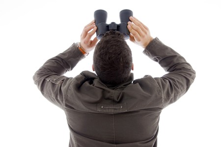 back pose of man using a pair of binoculars against white backgroundの写真素材