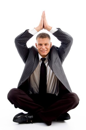 handsome young businessman performing yoga against white backgroundの写真素材
