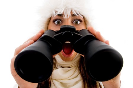 shocked female with binocular against white backgroundの写真素材