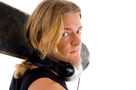 male looking at camera with skateboard against white background