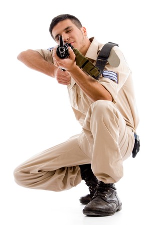 sitting soldier going to shoot with gun on an isolated background
