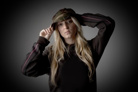 portrait of young female holding her cap with white backgroundの写真素材