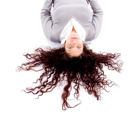 woman laying down on floor with hair spread out on white background